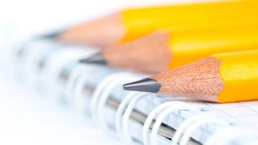 3 Pencil ends sitting on a notebook