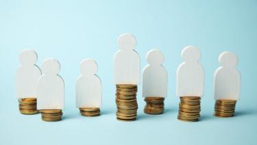 iStock Image - Pay Transparency Concept Figures of people on stacks of coins. Different levels of people's earnings