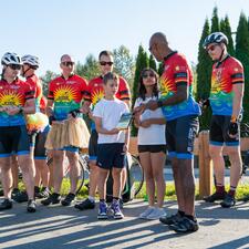 Two students accepting a plaque for their participation in raising funds for the Cops for Cancer/Tour de Valley.