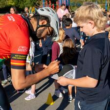 Tour de Valley rider signs a student hat.